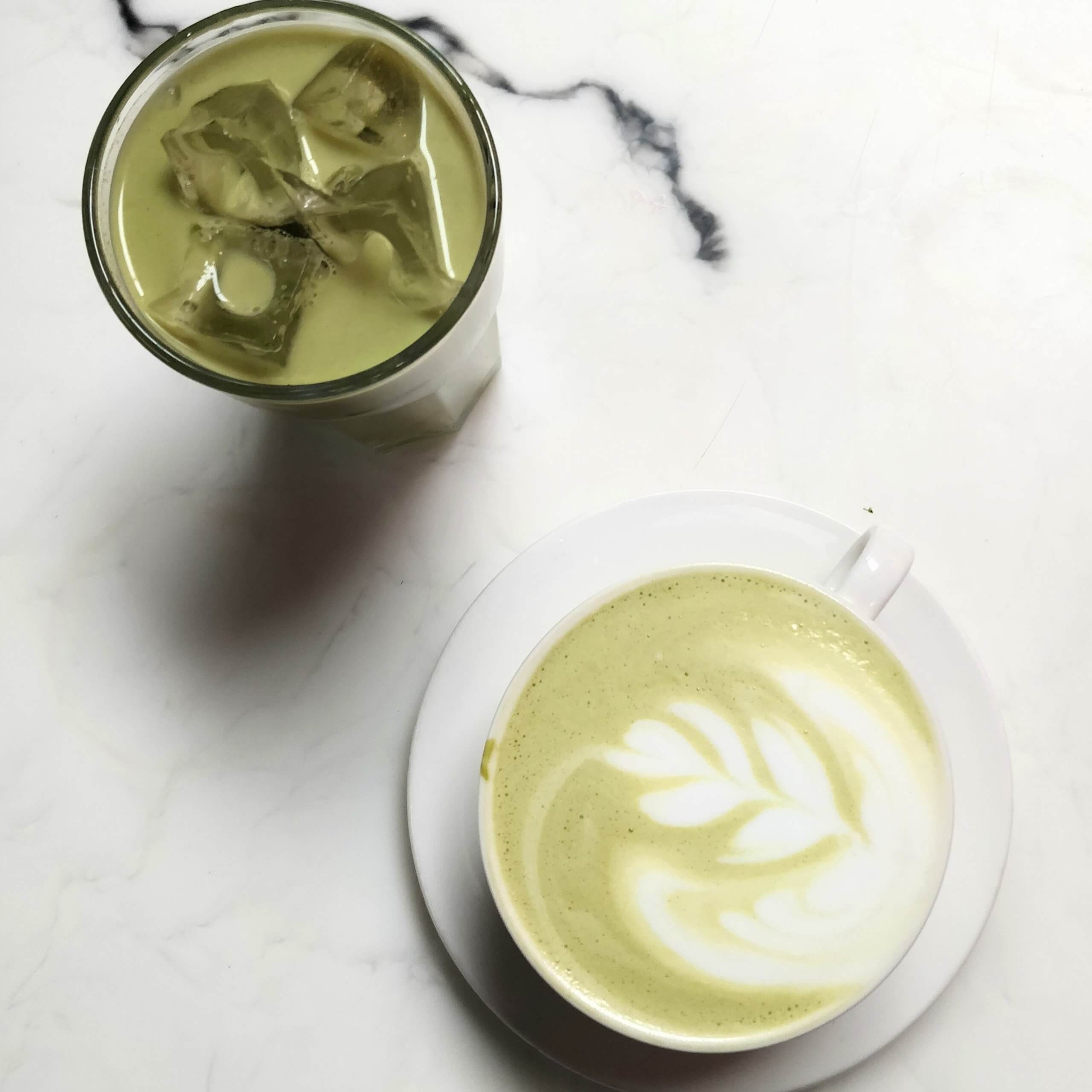A close-up of a cup of frothy matcha tea.