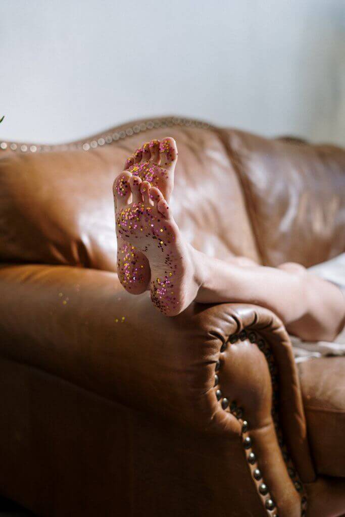 A decorative pillow with positive affirmations on a cozy couch.