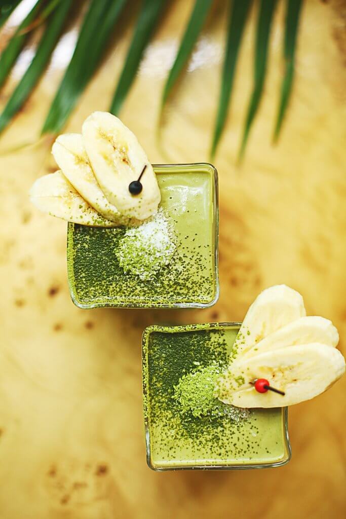A delicious-looking smoothie bowl topped with banana slices and seeds.