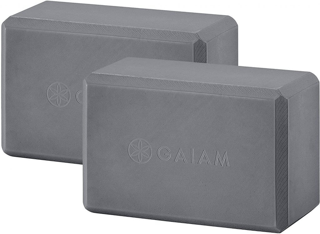 A set of two high-density foam yoga blocks and a strap.
