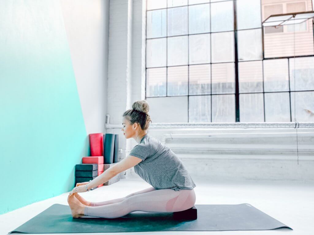Woman in a Seated Forward Bend.