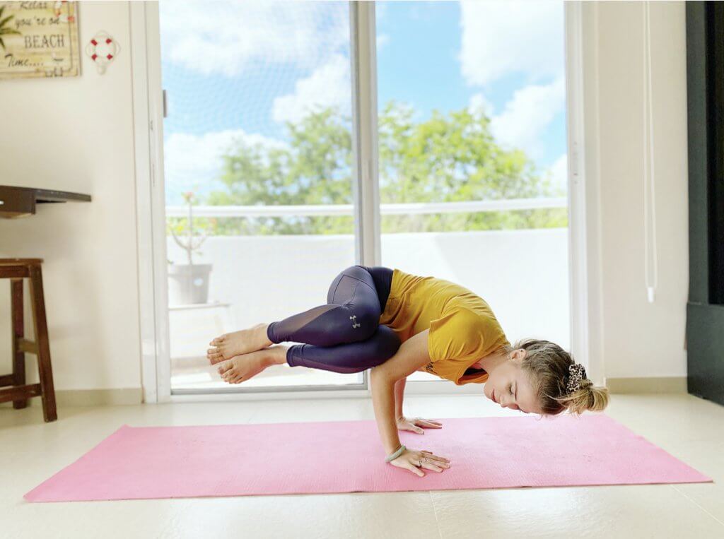 Woman demonstrating a strong yoga posture, highlighting strength and balance.