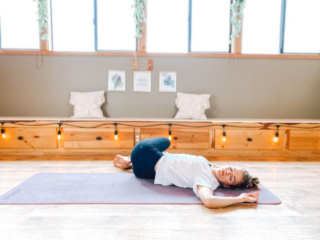 Woman in a gentle Supine Reclined Twist.