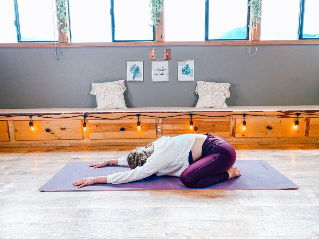 Woman in a restorative Child's Pose.