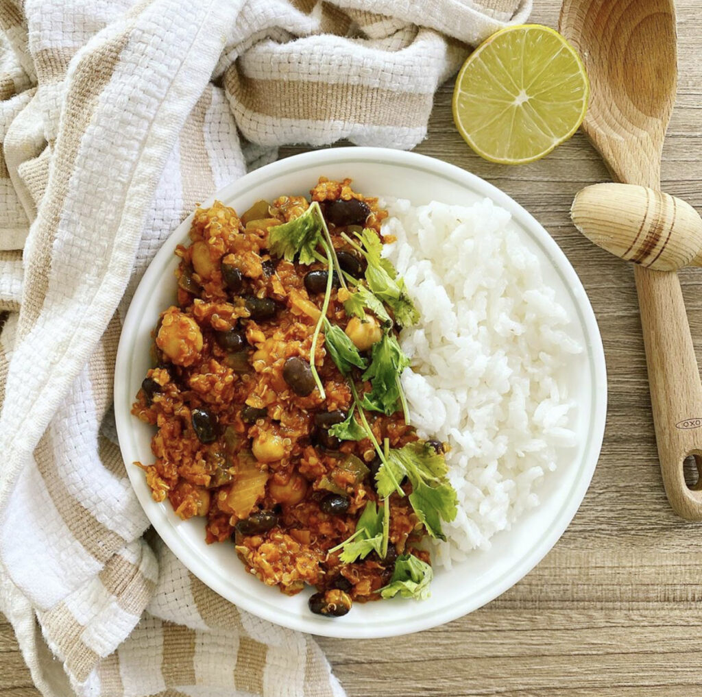 A hearty bowl of vegan chili with fresh toppings.