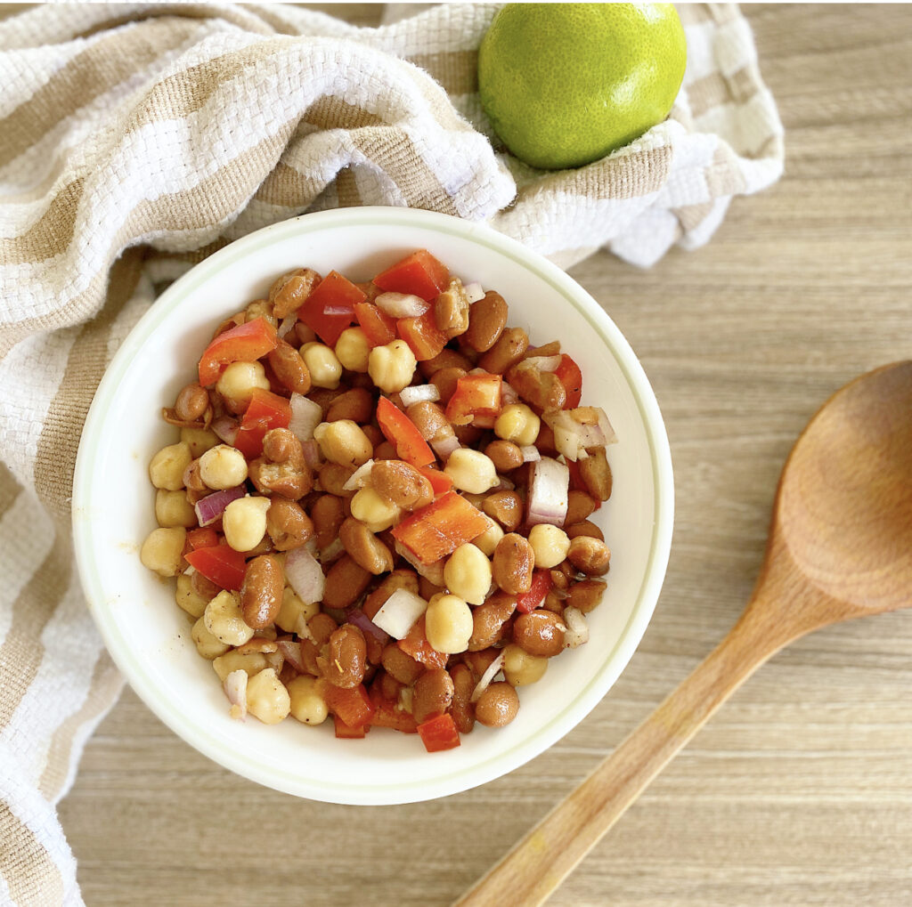 A healthy and colorful vegan protein bowl with chickpeas and kidney beans.