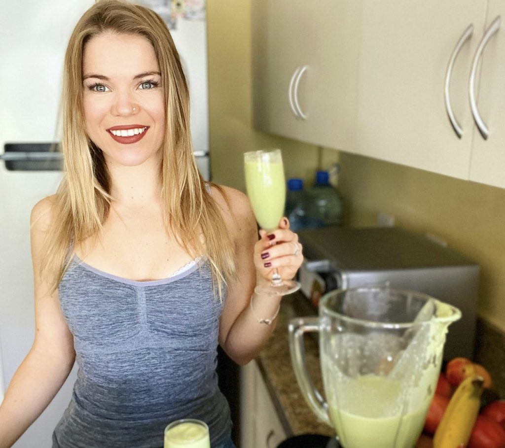 A green avocado smoothie in a glass, ready to drink.